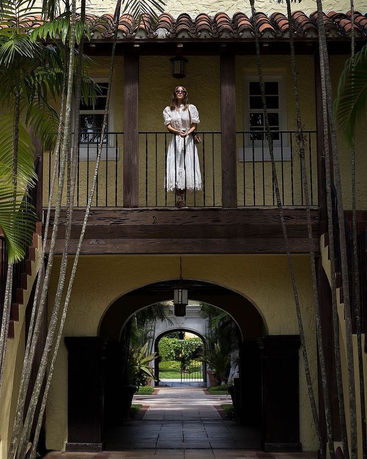 A girl standing on a balcony at Brazilian Court 