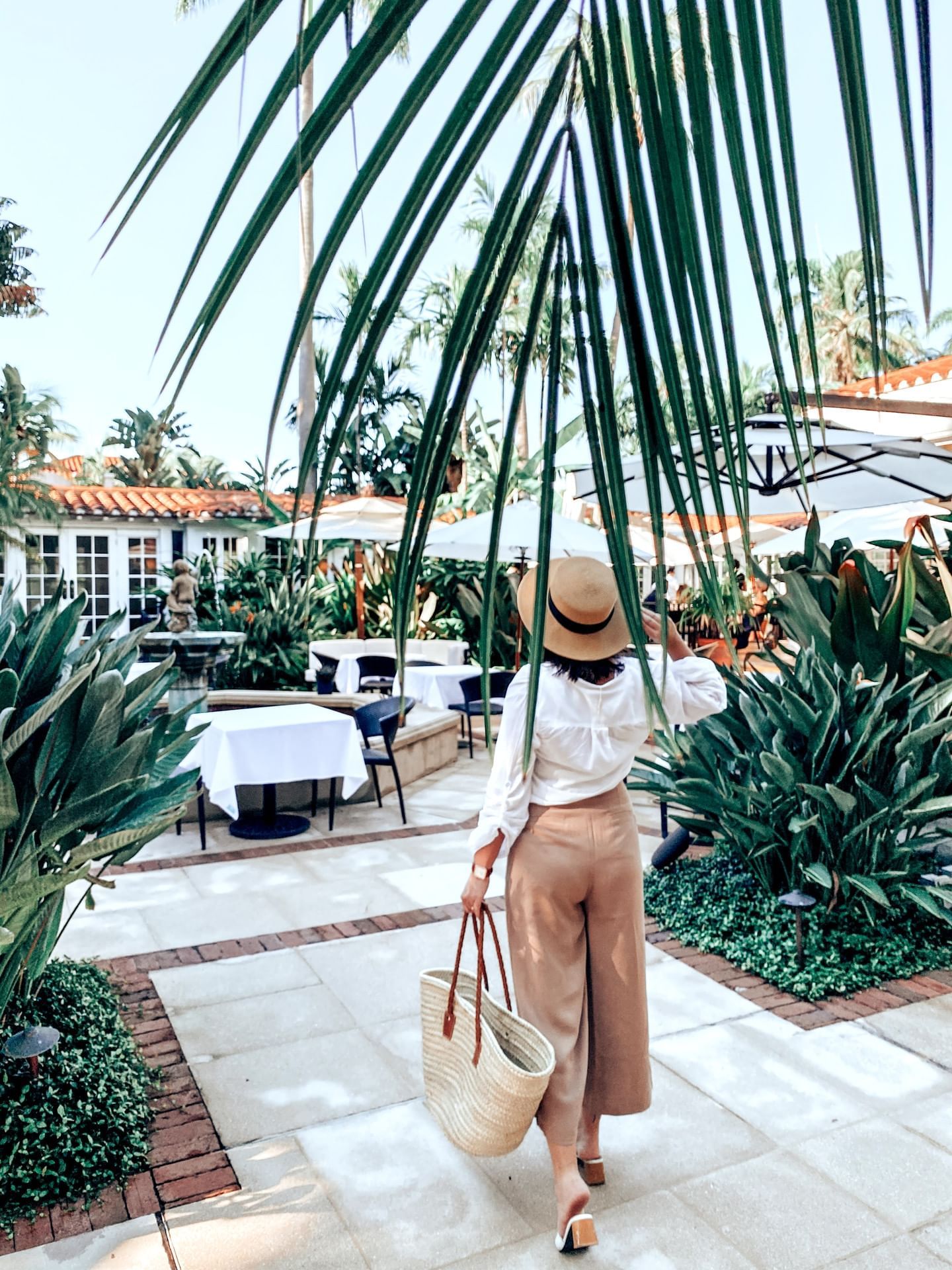 A girl standing in outdoor dining area at Brazilian Court
