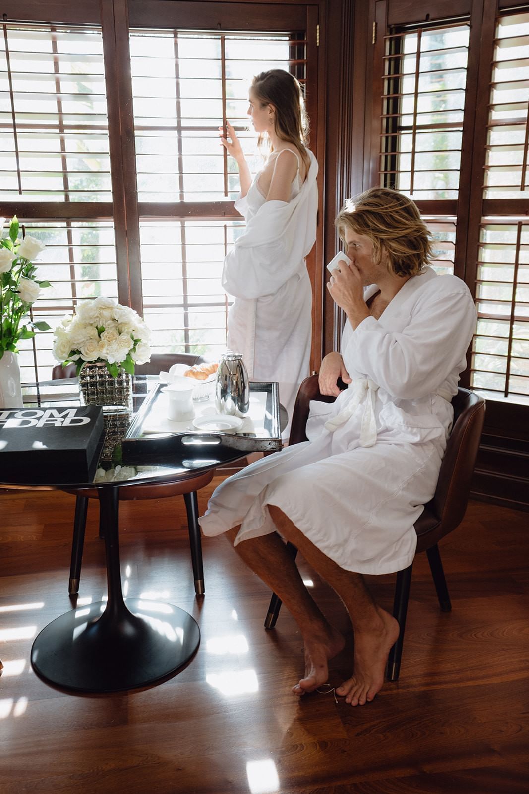 A couple relaxing with a sunset at Brazilian Court 
