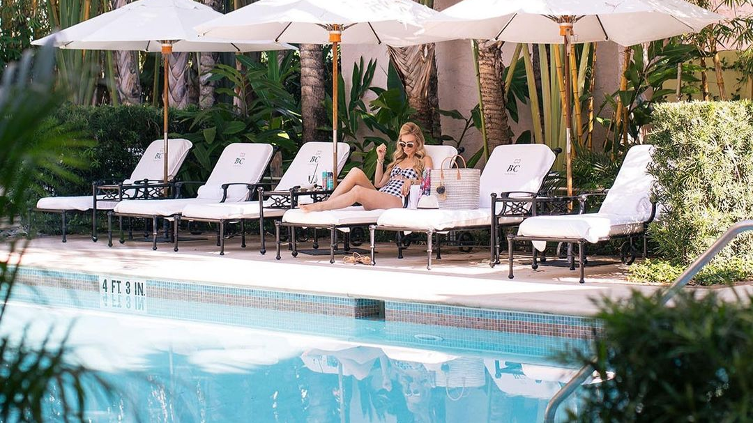 A girl lying on a lounger near the  pool at Brazilian Court